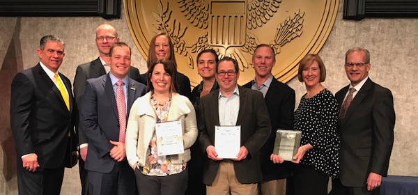 Group stands on stage to receive awards