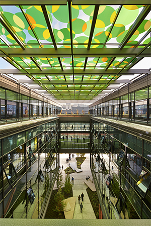 Interior of an office building with green circles on skylit ceiling