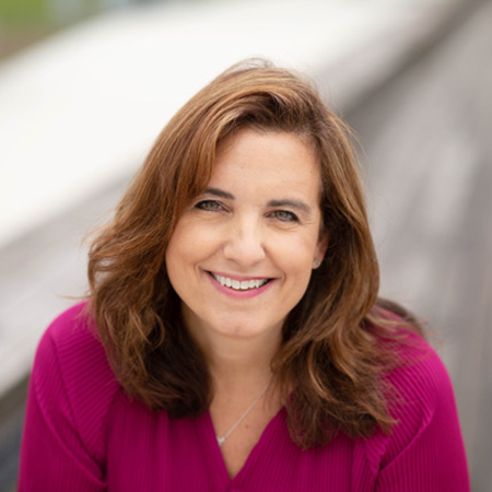 white woman faces camera and smiles